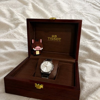 Watch in a box — linen — the same shot after the background swap, the subject unchanged